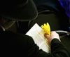 An attendee of Rabbi Hendel Weingarten's Purim service at Chabad House on Elizabeth Street in East Lansing uses a noisemaker after the name of Haman is read.